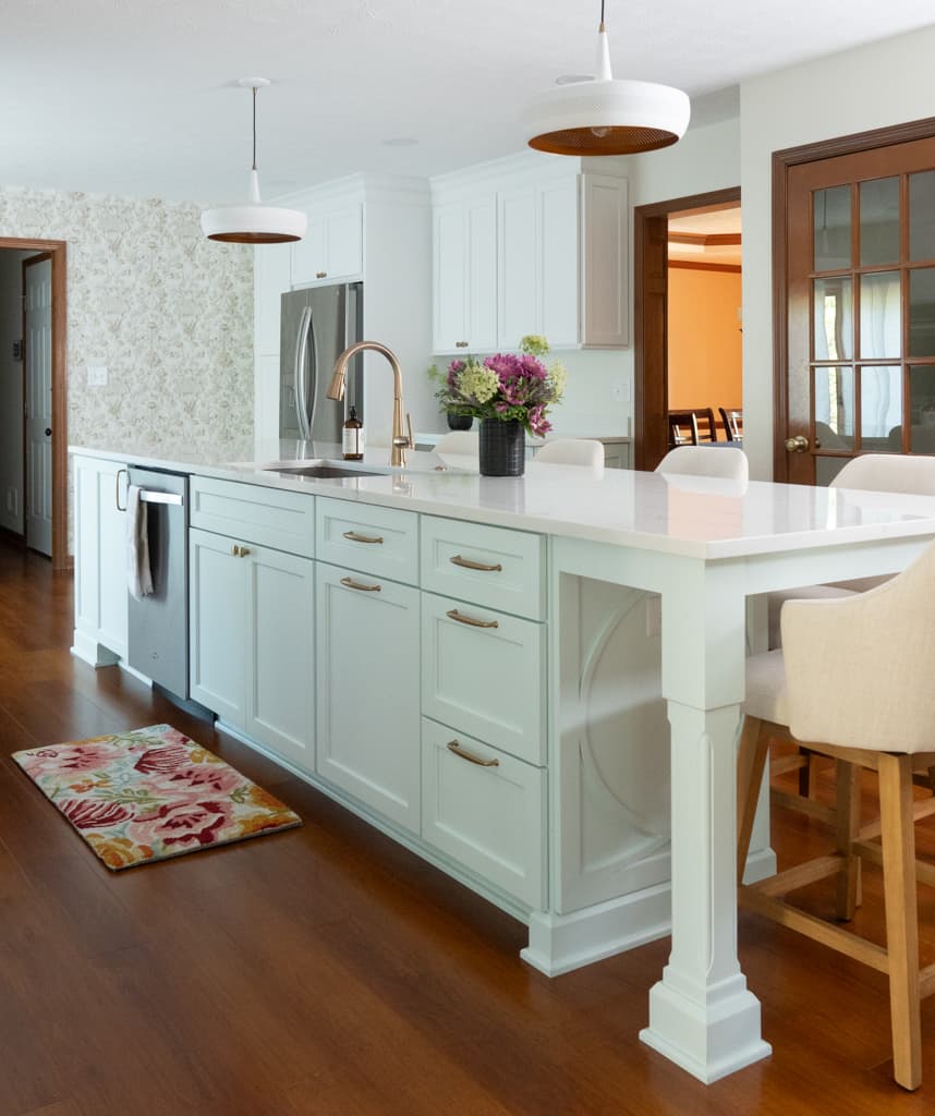 Nicholas Design Build |         A remodeled kitchen with a large island and chairs.