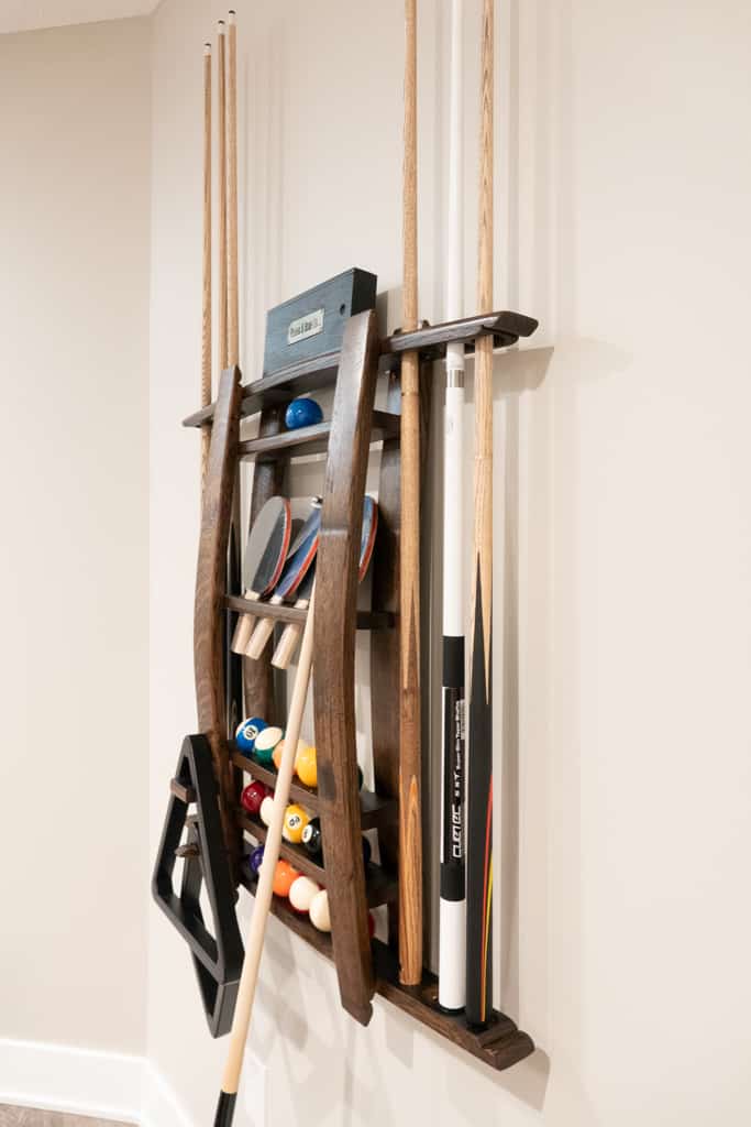 Nicholas Design Build | A wall mounted pool cue rack for a remodel project.