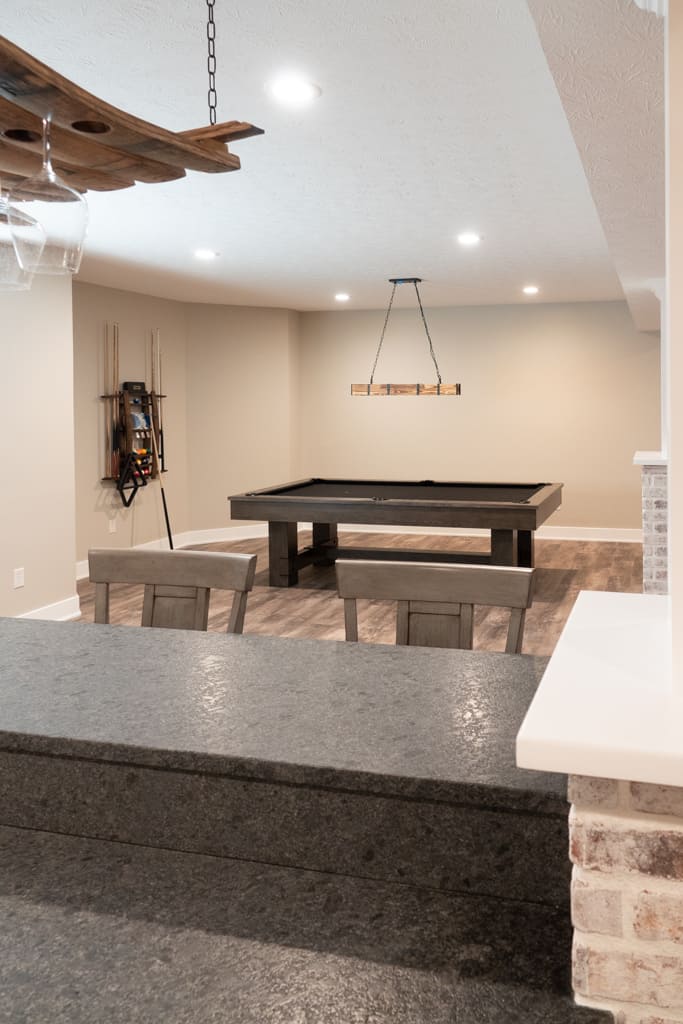 Nicholas Design Build | A basement remodel featuring a pool table and bar.