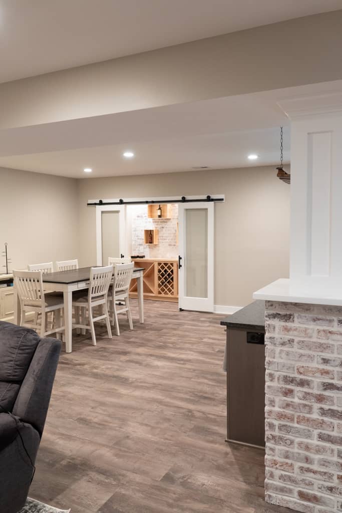 Nicholas Design Build | A remodeled living and dining room in a basement.