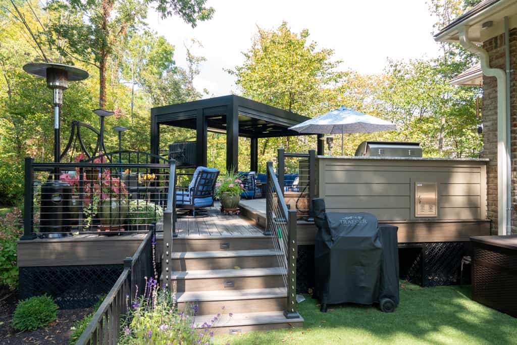 Nicholas Design Build | A backyard with a patio and a grill.