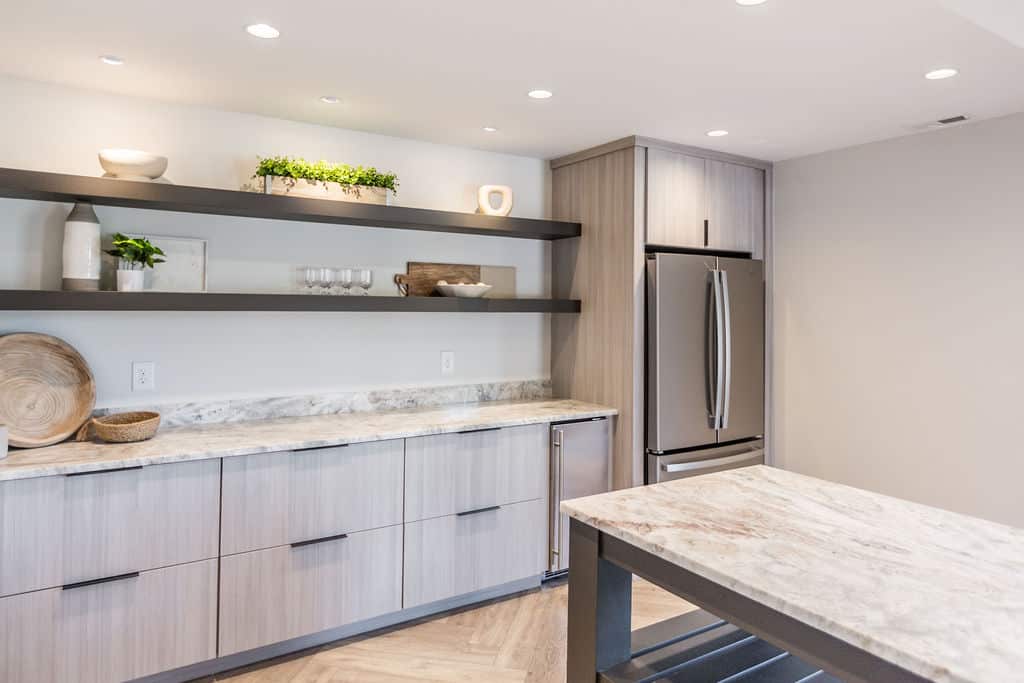 Nicholas Design Build | A kitchen with marble counter tops and stainless steel appliances.
