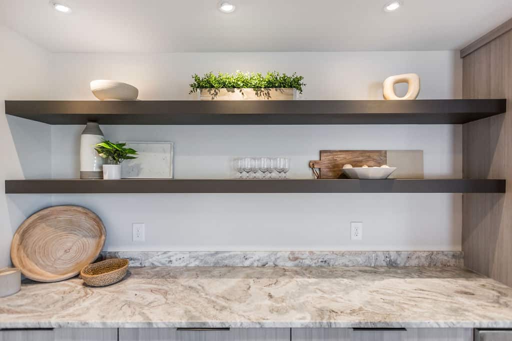 Nicholas Design Build | A kitchen with a marble counter top and shelves.