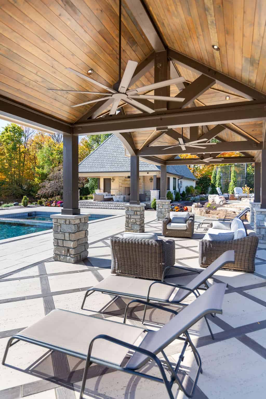 Nicholas Design Build | An outdoor patio with lounge chairs and a pool.