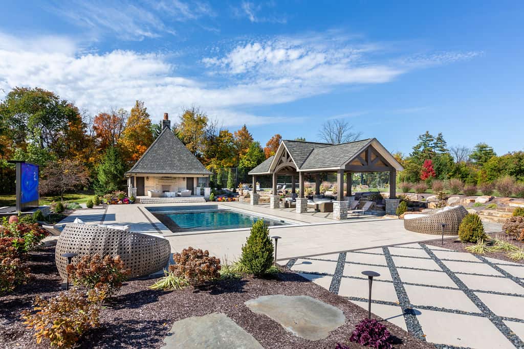 Nicholas Design Build | A backyard with a pool and patio furniture.
