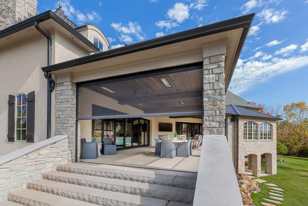 Nicholas Design Build | A home with a large patio and stone steps.